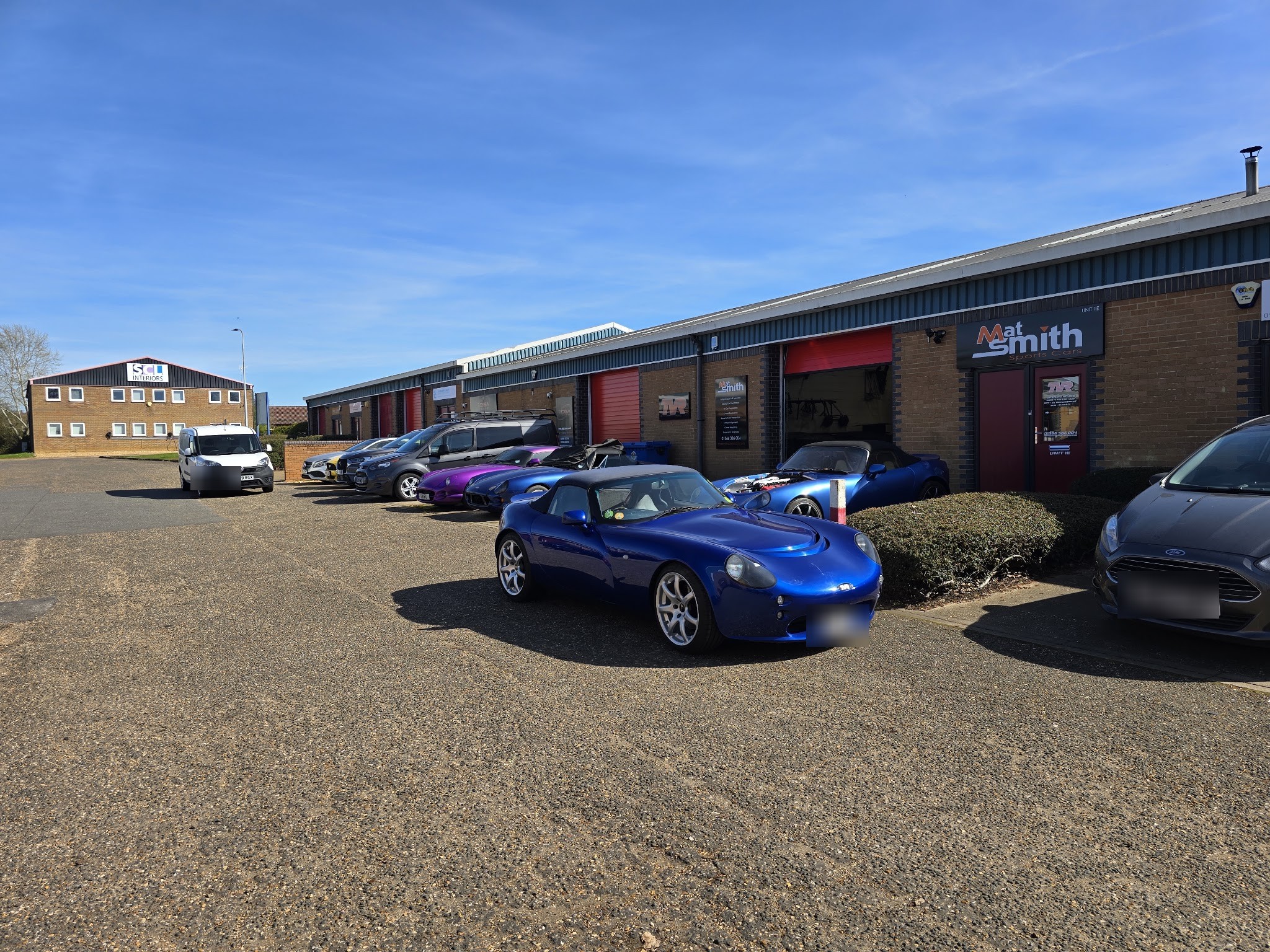 The row of units on Trafalgar Industrial Estate with the Mat Smith sign and a blue TVR Tamora outside