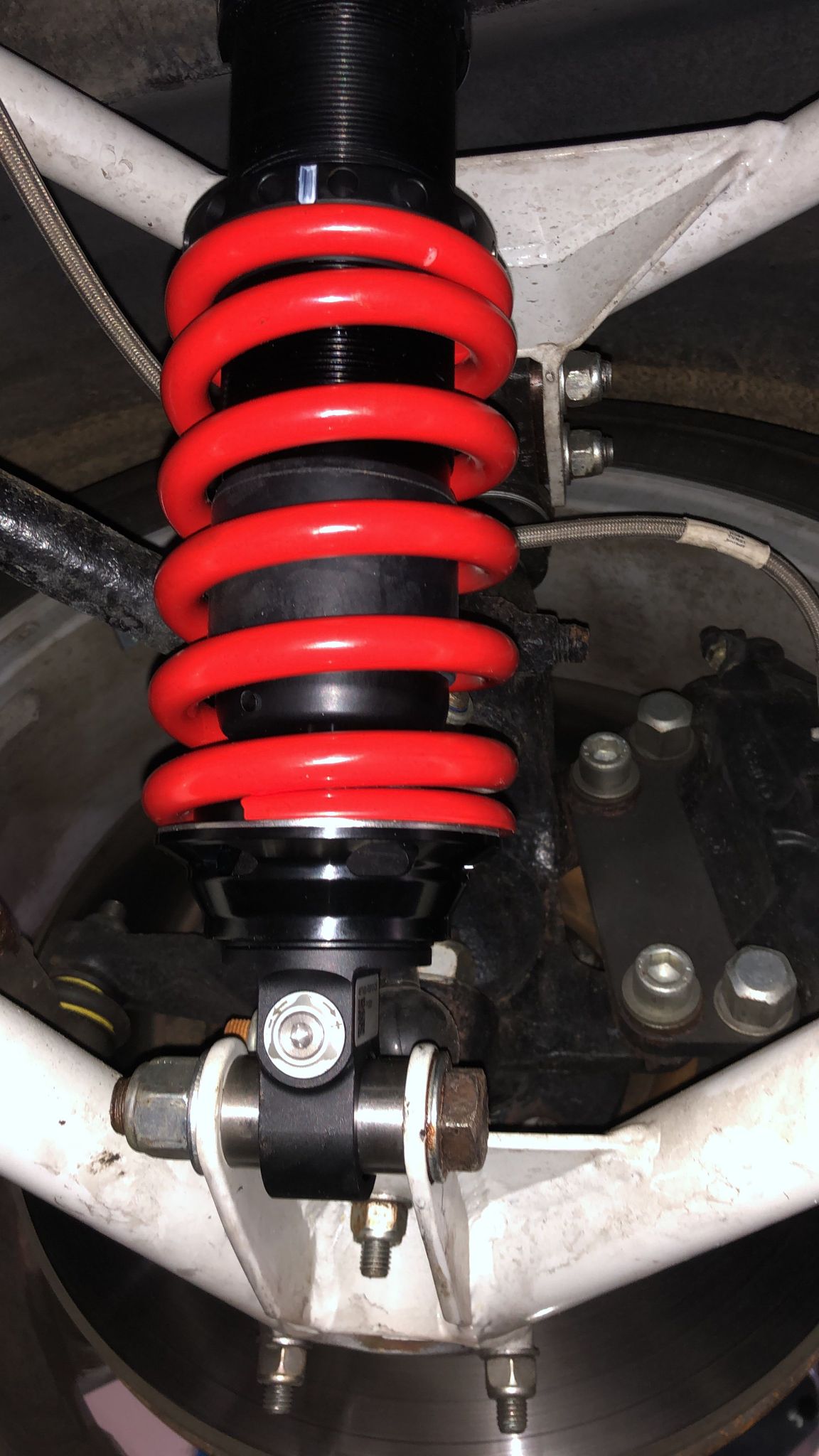 A red coilover spring fitted to a TVR chassis