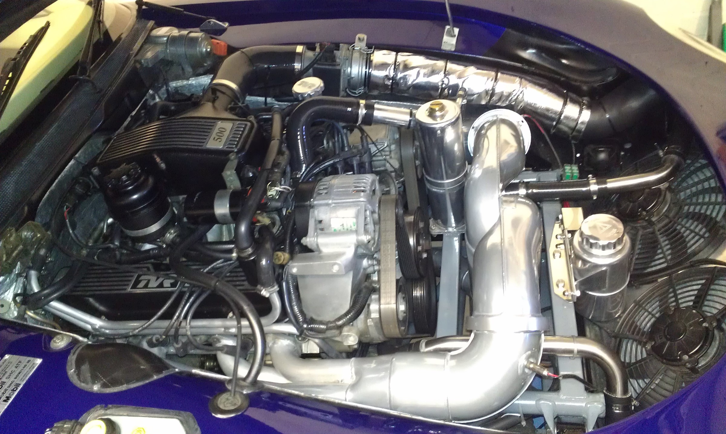The Griffith engine bay back together with a ceramic coated exhaust