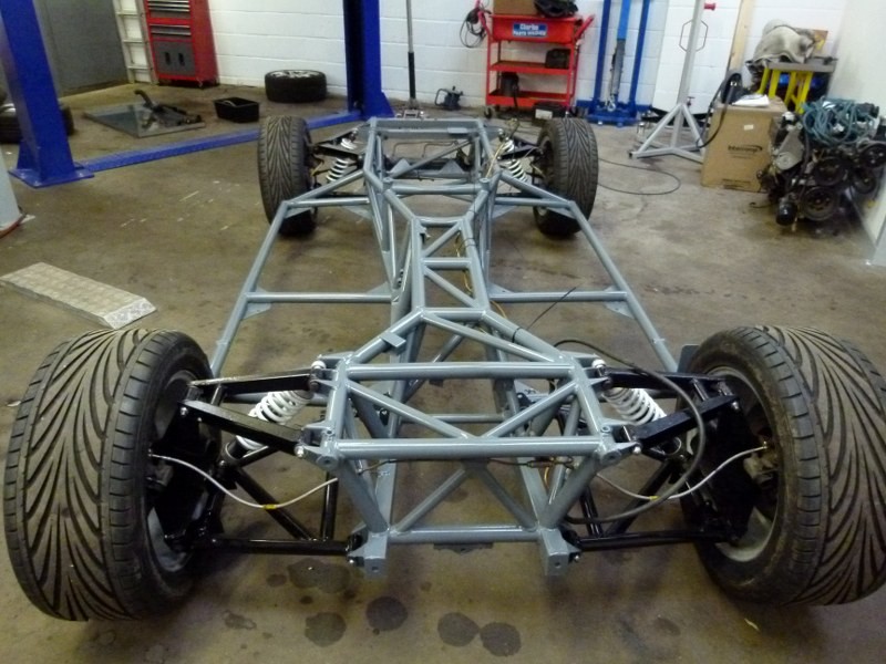 The restored Griffith chassis on its wheels, reassembled with the suspension
