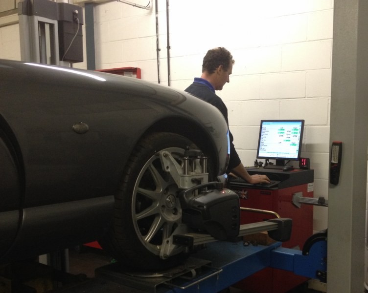 A technician at the alignment computer beside a TVR on the ramp
